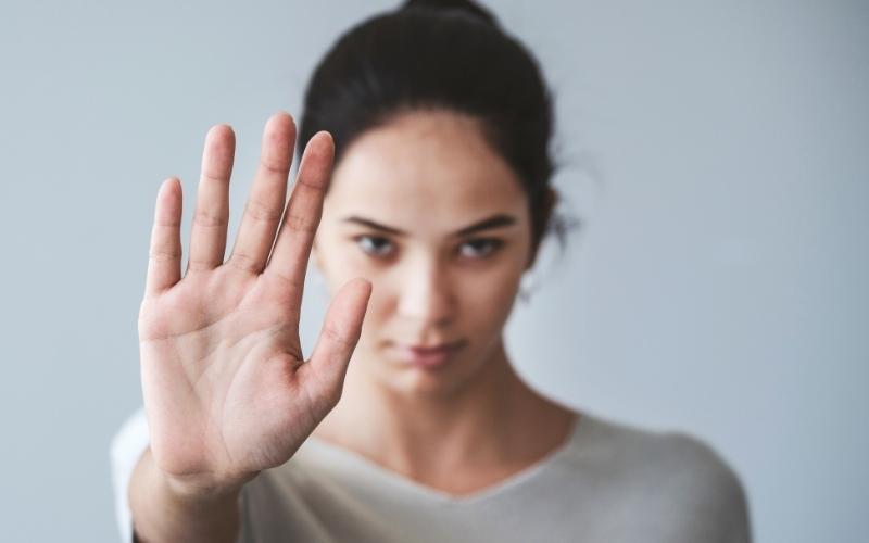 woman with hand signalling stop