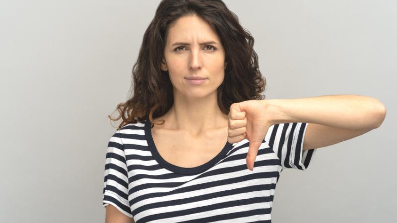 woman with thumb down