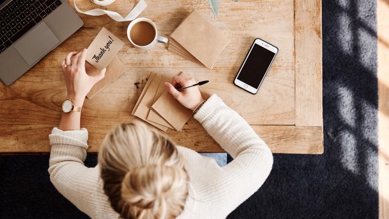 woman writing thank you cards